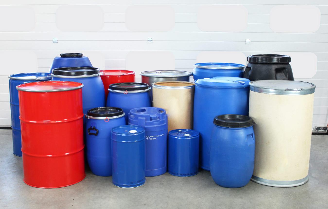 A range of different drums for industrial material handling on the STS warehouse floor.