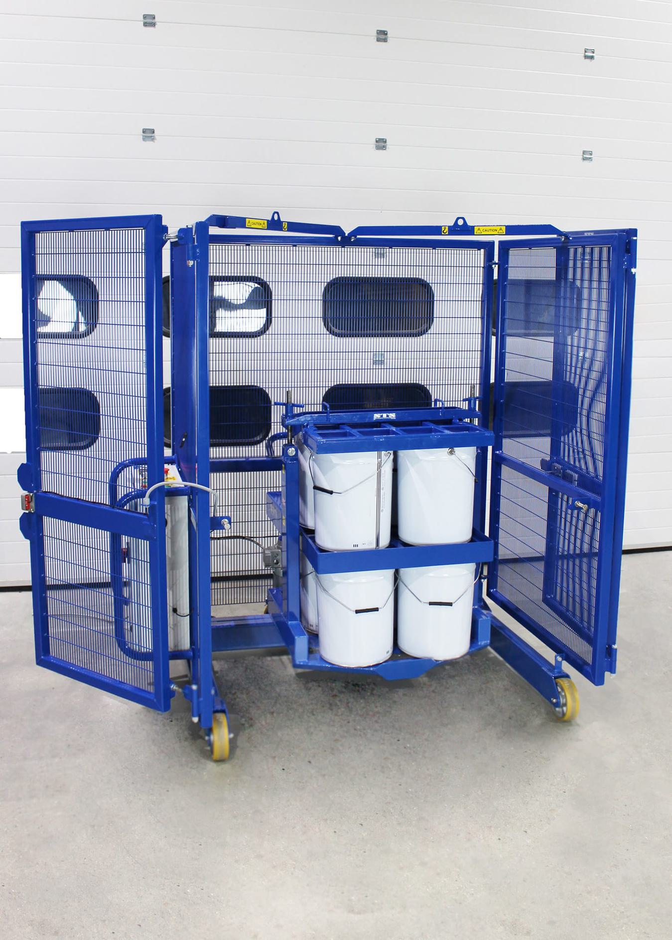A paint drum mixer by STS with the mixing cage doors open.