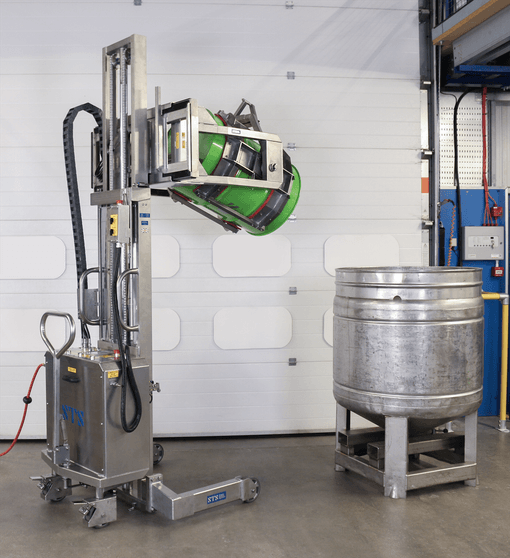 The drum tipper emptying a green 205-litre steel drum.