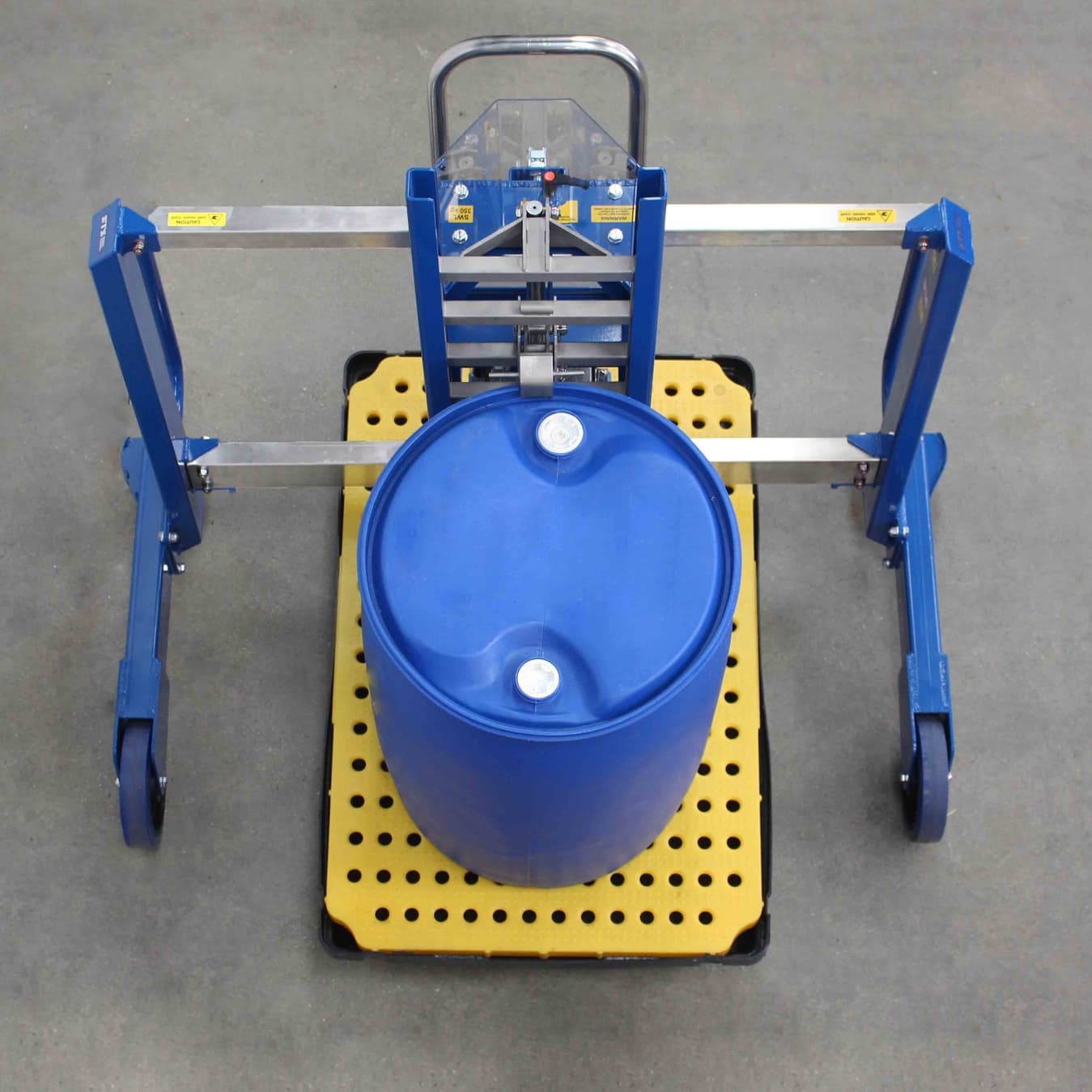 Drum lifter moves drum on a spill pallet