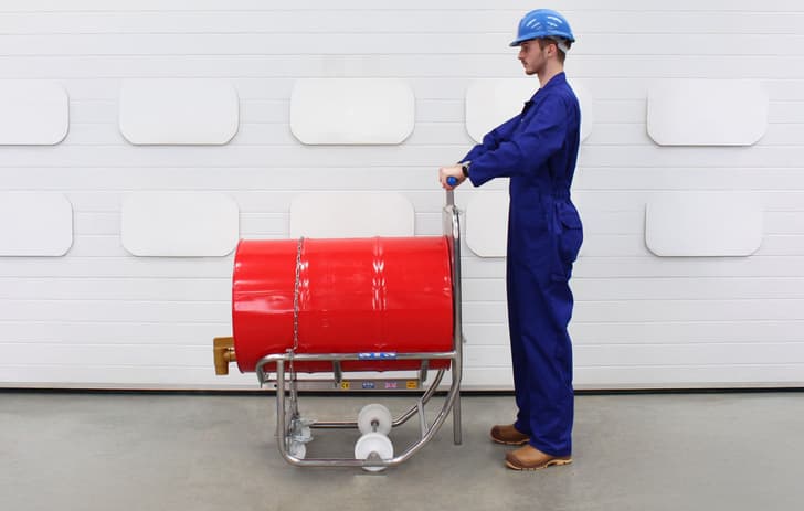The operator holds the handle of the STS drum dispenser
