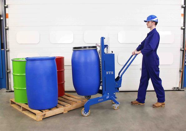 An operator uses an STS drum lift depalletiser for manual handling a range of drums