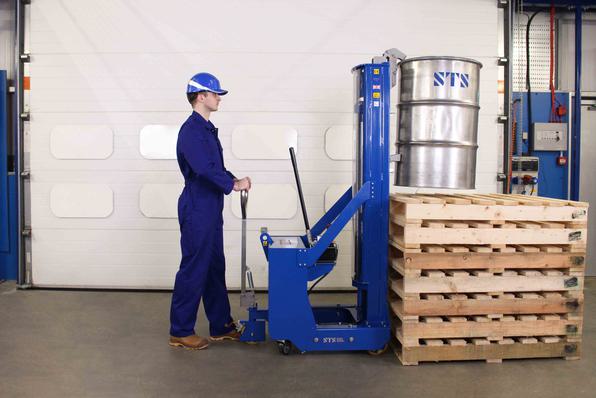 Operator approaches raised platform with the counterbalance drum stacker.
