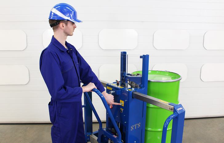 Operator uses a press button to operate the electric lift function on the DTP04 drum lifter.