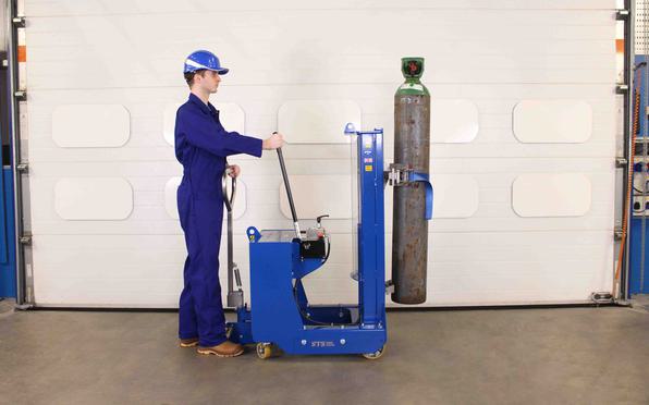 Operator pumps the manual-hydraulic hand pump on the gas cylinder lifter.