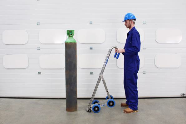 An operator preparing to load a gas cylinder onto the Gas Cylinder Trolley