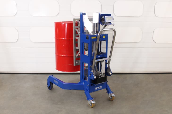 A weigh scale digital display shows the weight of liquid in a 200 litre drum