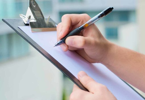 A operator uses a maintenance checklist to look at a range of drum handling equipment